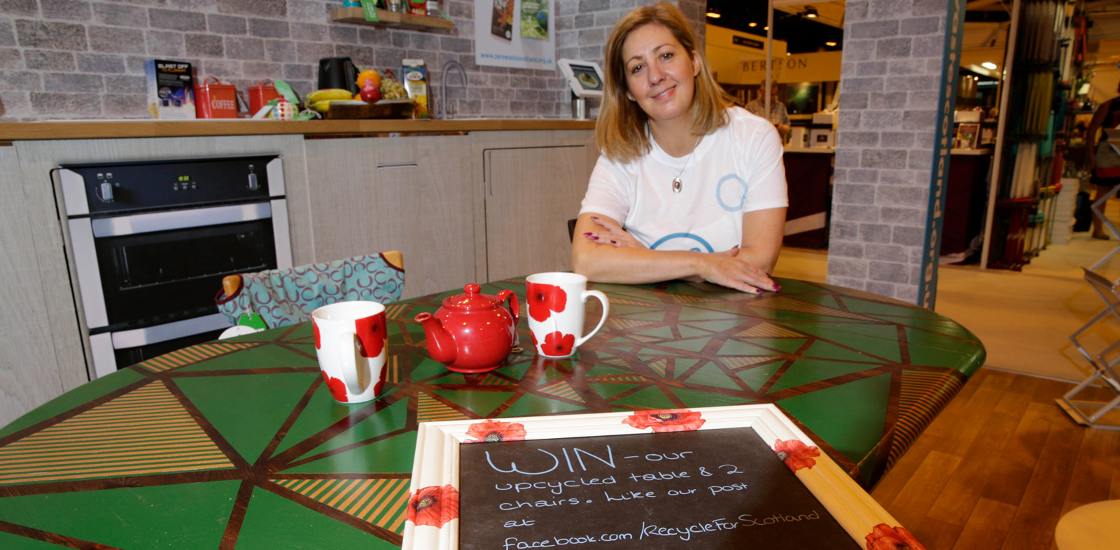 Zero Waste Scotland’s Linda Mann shows off our fabulous upcycled table, from Revolve-certified Reconect Glasgow, upcycled by Pineapple Chunks Design, which visitors had the chance to win.